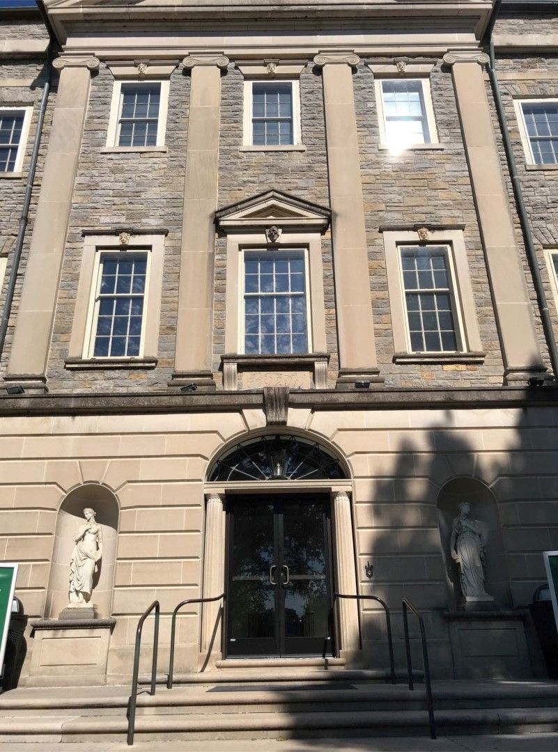 Storefronts & Glass Doors Installation and Repair - A large brick building with a statue in front of it.