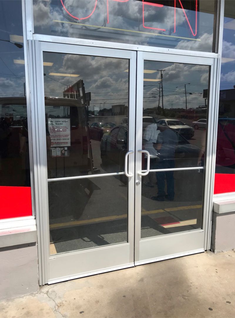 Storefronts & Glass Doors Installation and Repair - A store front with a sign that says open on it
