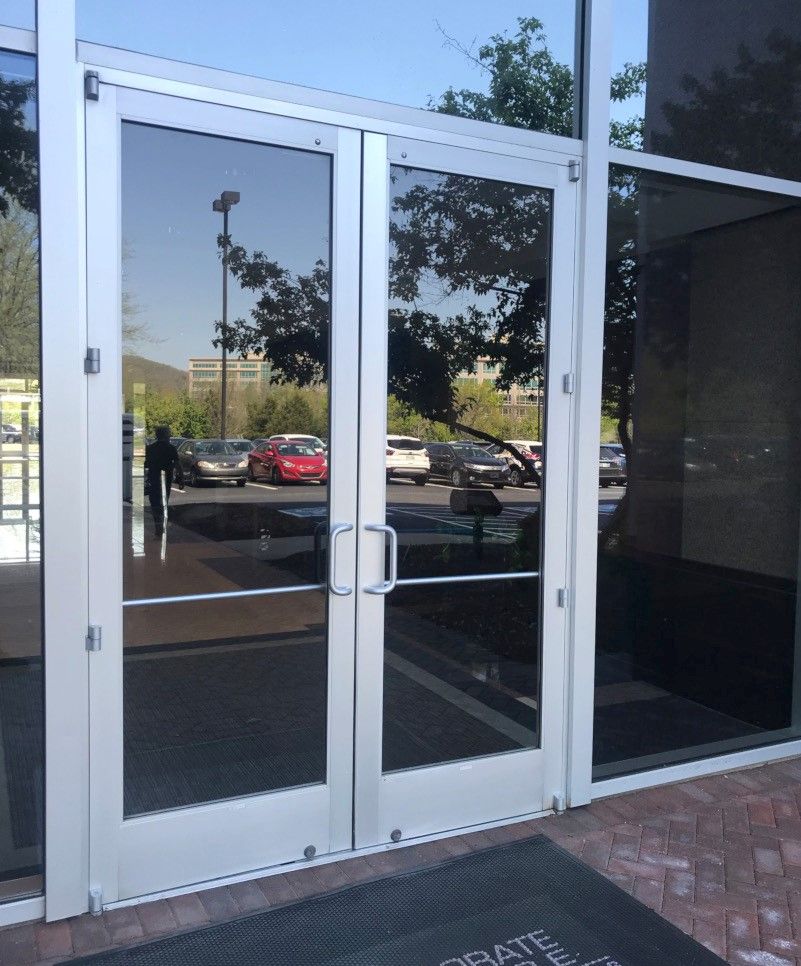 Storefronts & Glass Doors Installation and Repair - A glass door with a mat that says ' gratefulness ' on it