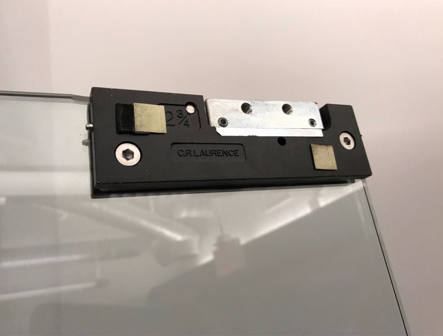 Storefronts & Glass Doors Installation and Repair - A close up of a piece of hardware on a glass door.