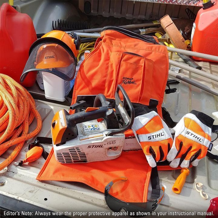 A stihl chainsaw sits in the back of a truck