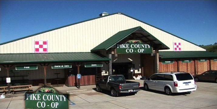 A pickup truck is parked in front of the pike county co-op
