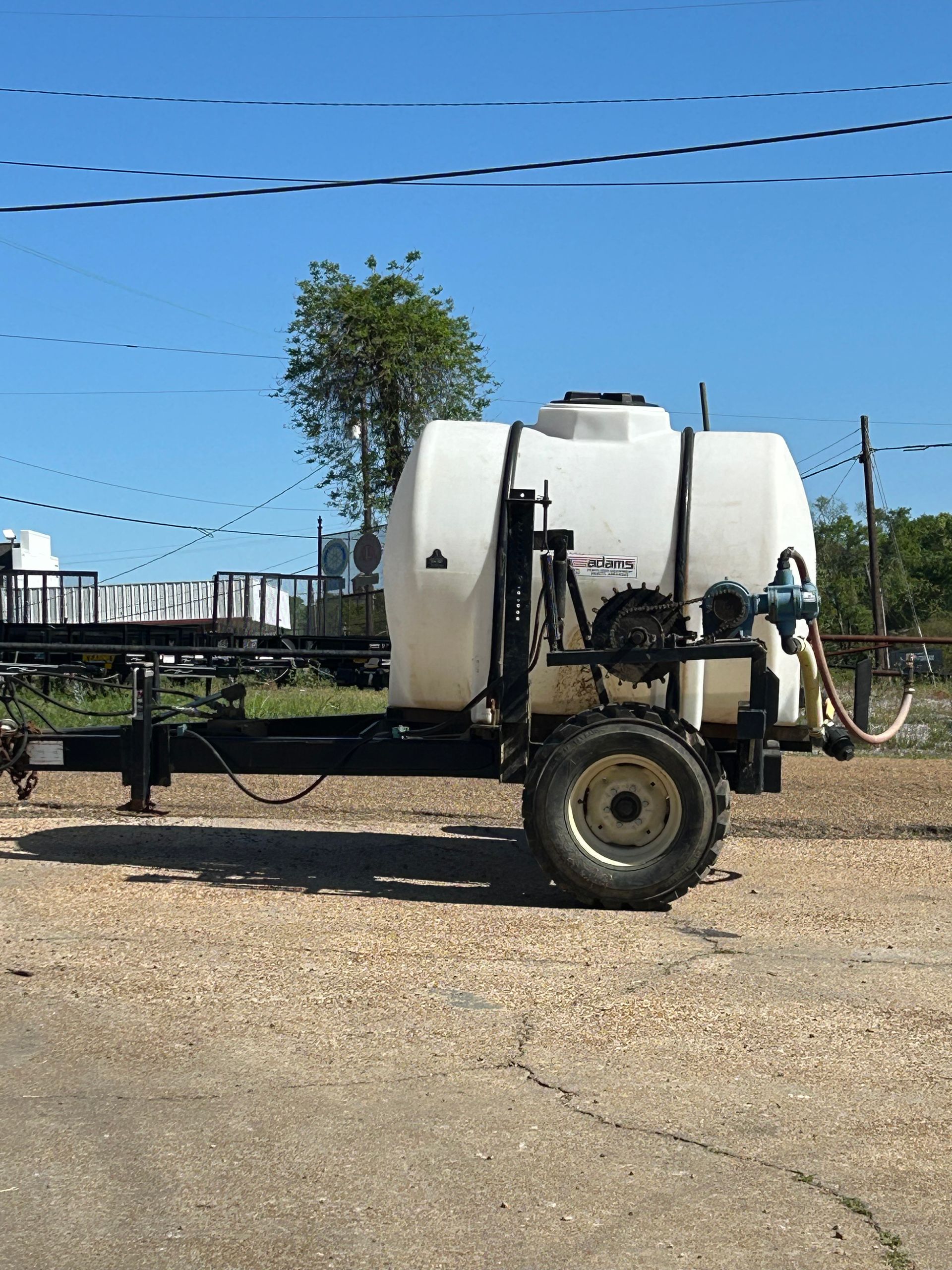 A person is spraying a tree with a sprayer.