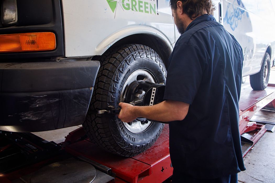 Technician measuring wheels on a fleet vehicle in our garage in Centerville, UT | Baker Automotive
