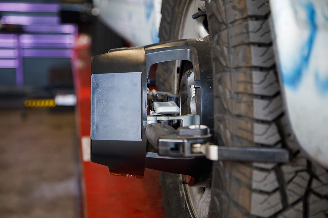 Up close to alignment tool on a tire of a fleet vehicle in our garage in Centerville, UT | Baker Automotive