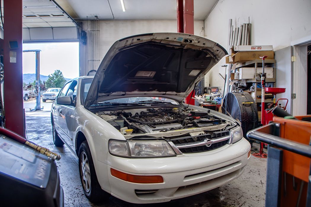 White car with hood up in our garage in Centerville, UT | Baker Automotive