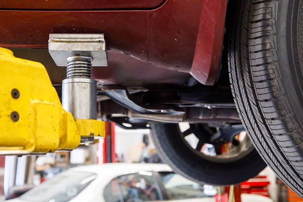 Underneath lifted vehicle in our garage in Centerville, UT | Baker Automotive