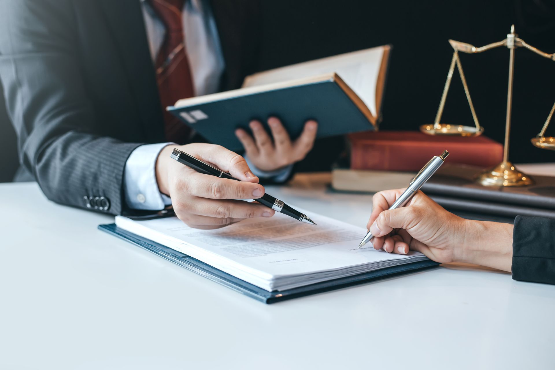 Bankruptcy lawyer reviewing wage garnishment documents with a client at a desk.