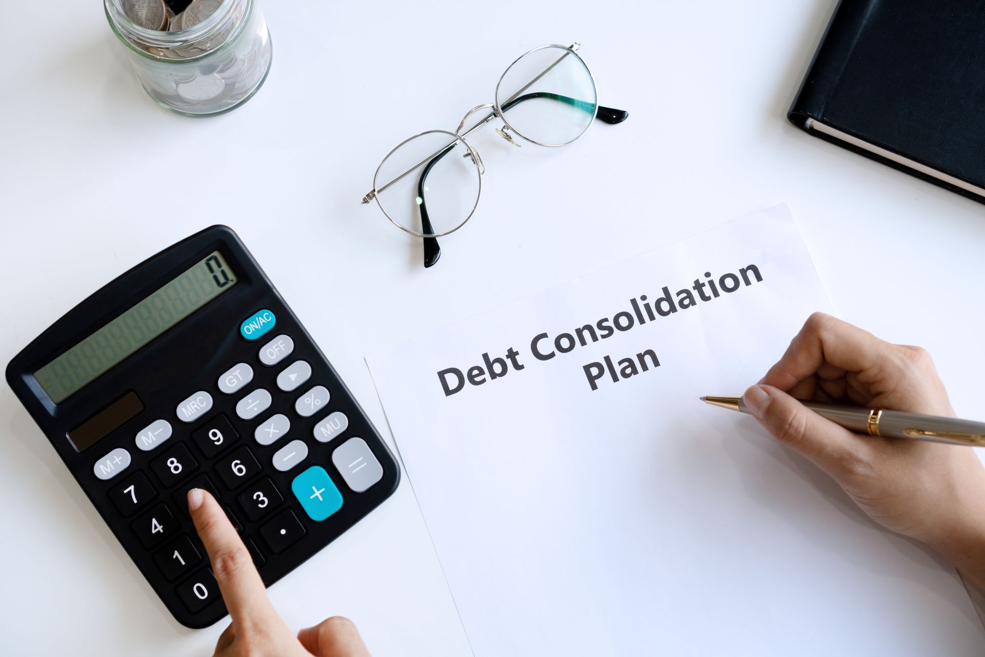 Creating a debt consolidation plan with a calculator. Creating a debt consolidation plan with a calculator.