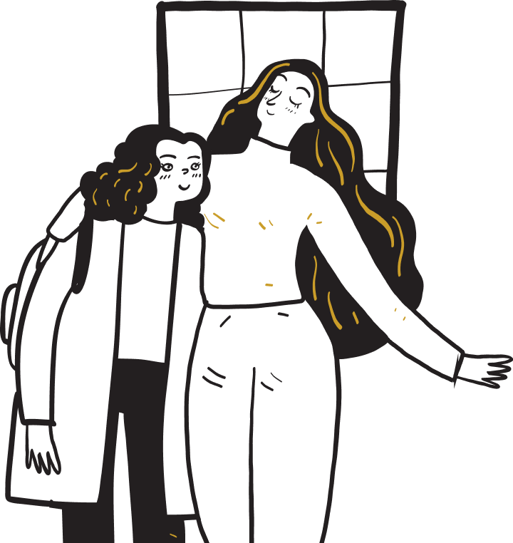 Two people standing together indoors, one in white with long dark hair and one in a dark coat.