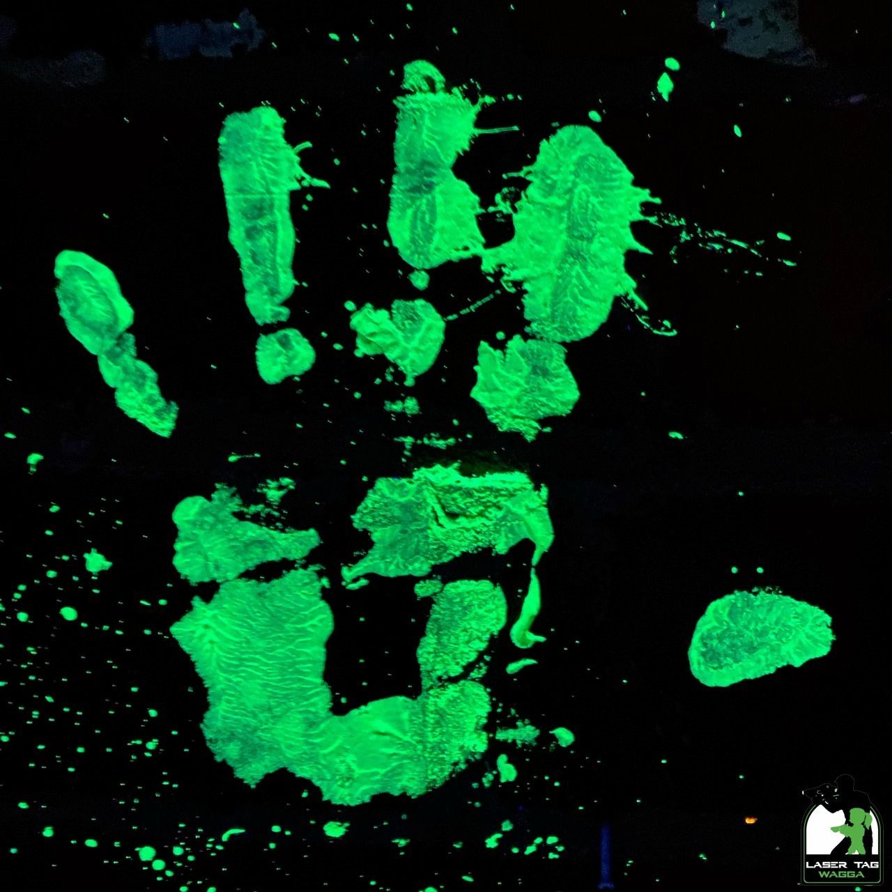 A Glow In The Dark Hand Print On A Black Background In Laser Tag — Laser Tag Wagga In Wagga Wagga, NSW