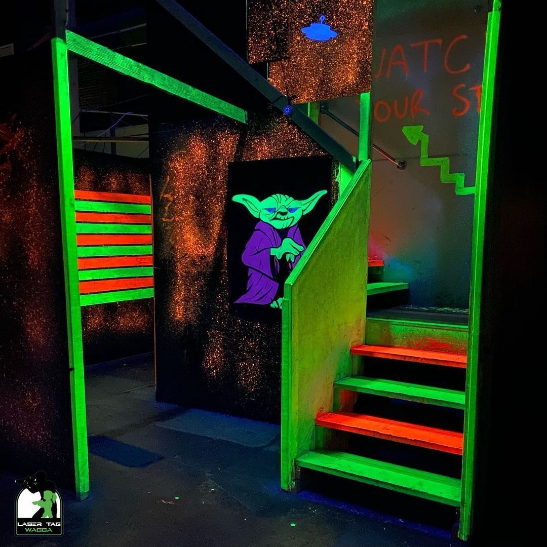 A Glow In The Dark Room With Stairs And A Sign That Says Watch Your Step In Laser Tag — Laser Tag Wagga In Wagga Wagga, NSW