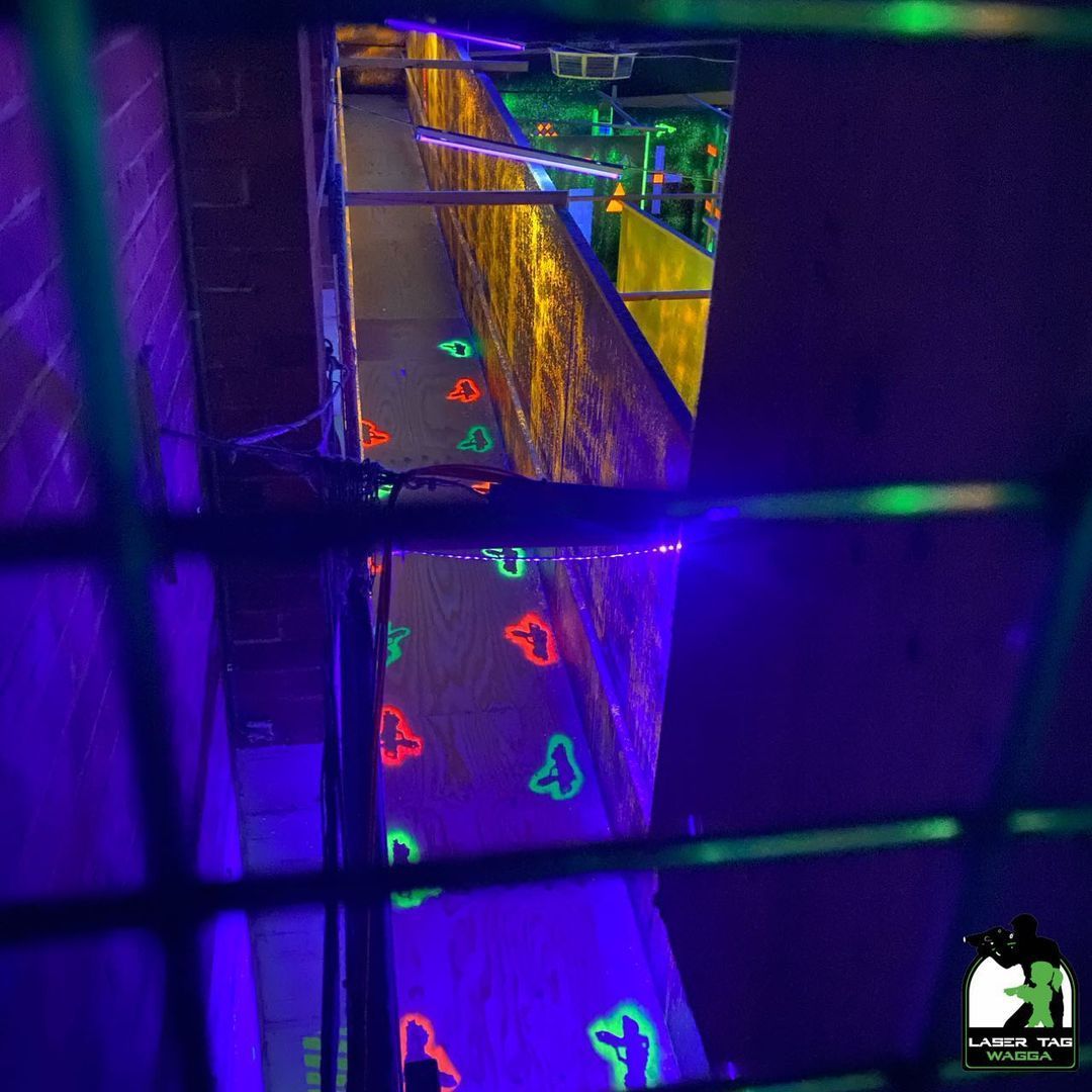 A Dark Room With Neon Lights On The Floor And Walls For Laser Tag — Laser Tag Wagga In Wagga Wagga, NSW