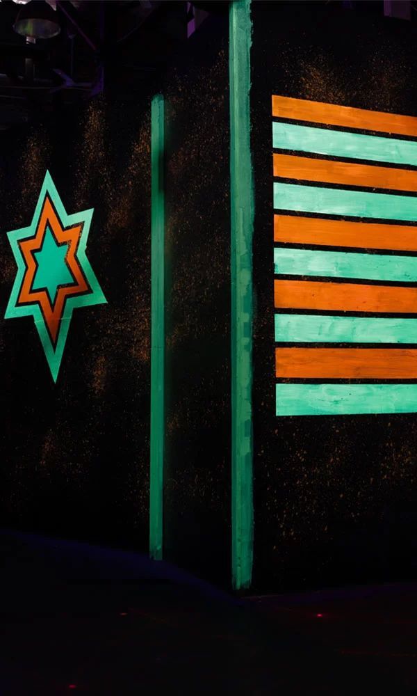 A Star And A Striped Flag Are Glowing In The Dark For A Game Of Laser Tag — Laser Tag Wagga In Wagga Wagga, NSW