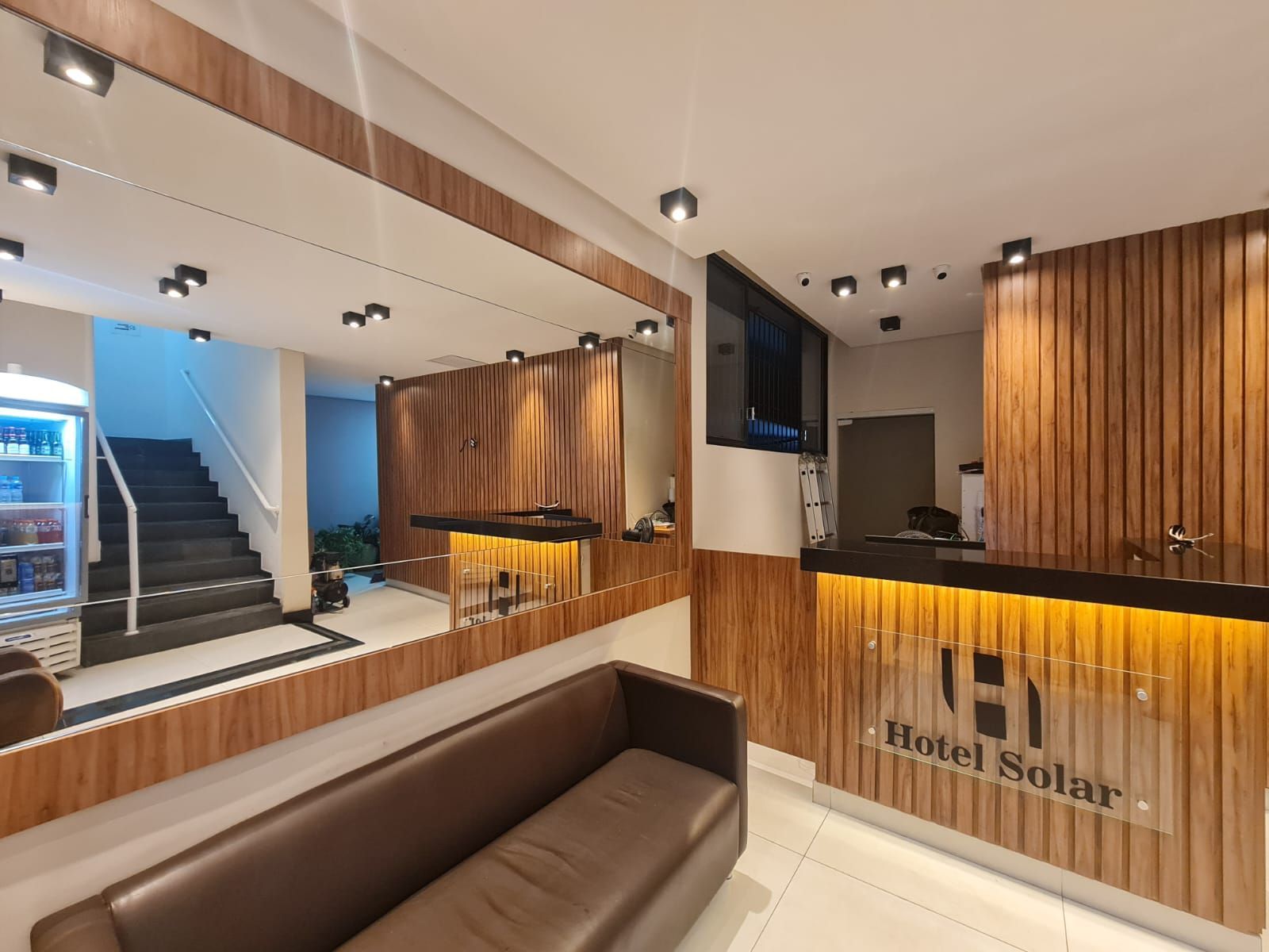 Um lobby de hotel com um sofá e um balcão - Hotel Solar Bela Vista