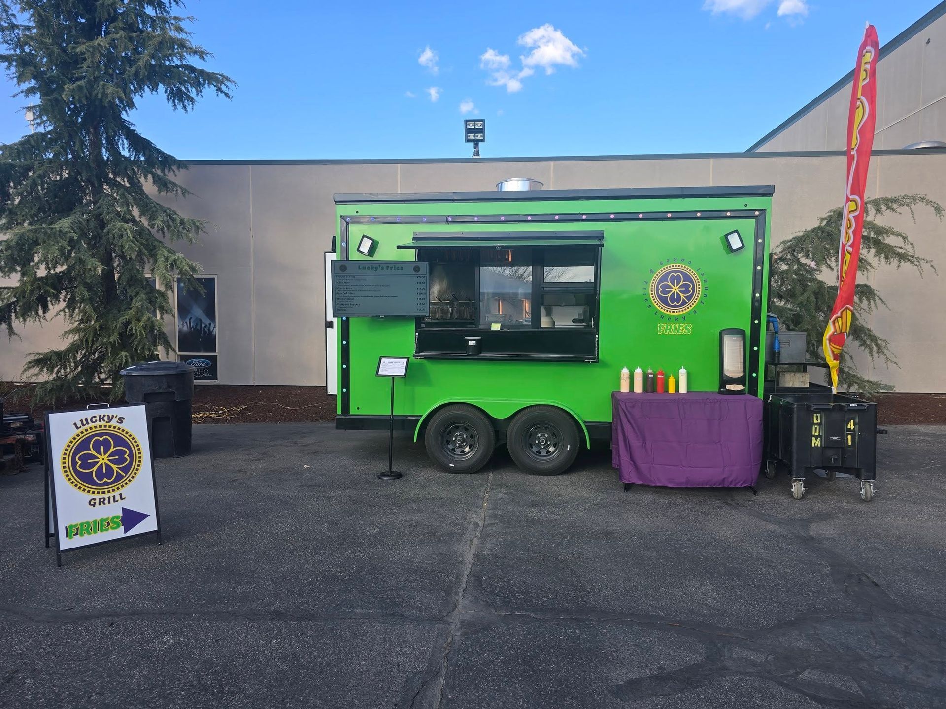 Lucky's Grill green trailer set up at an event