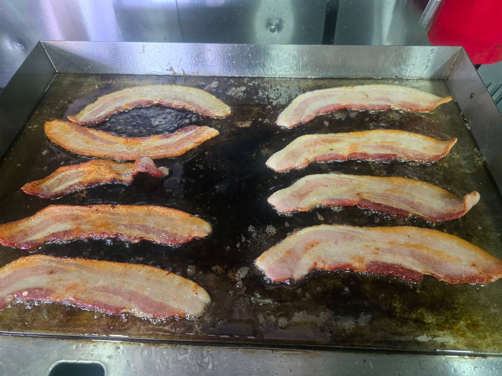 Pork tenderloins cooking on the flat-top grill