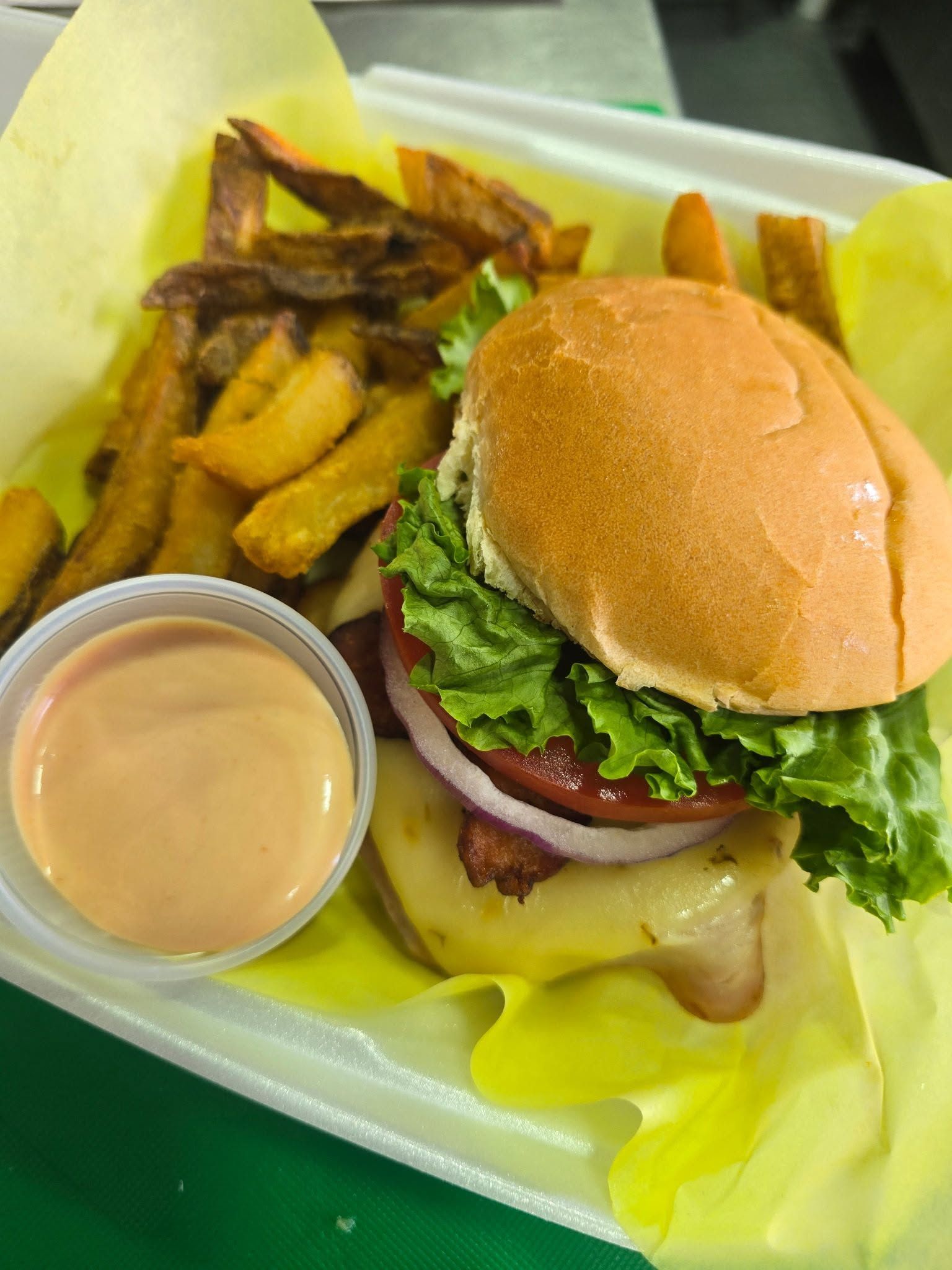 Burger with a basket of fresh cut fries