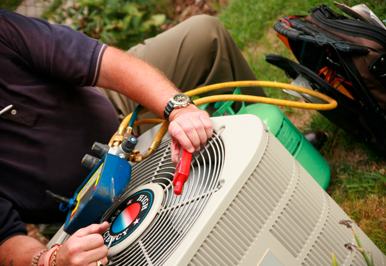 Service Technician performing maintenance on a Air Conditioner