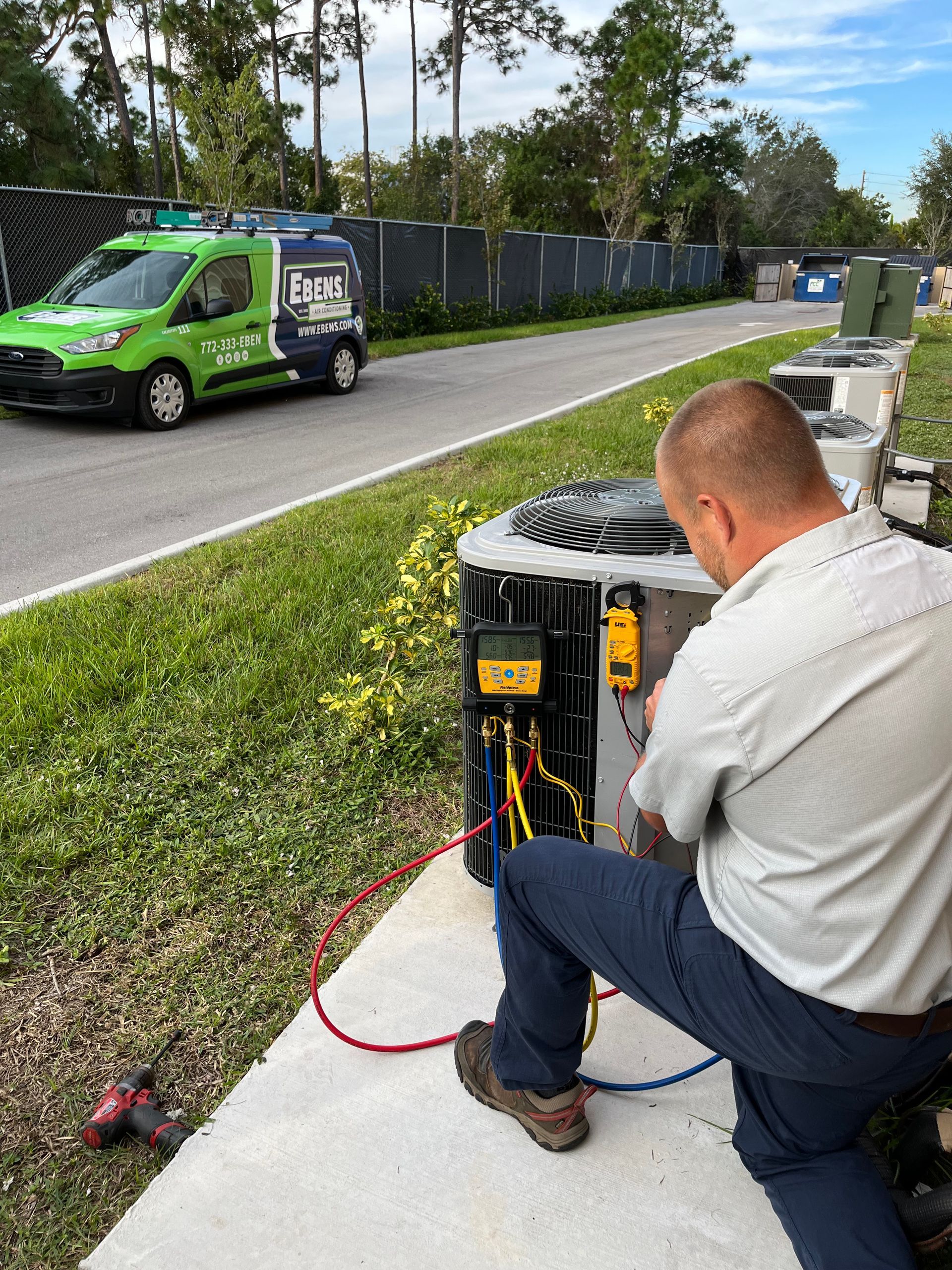 AC technician repairing an air conditioning unit