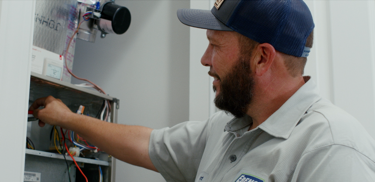 Ebens Air Conditioning Service Technician working on an Air Conditioner