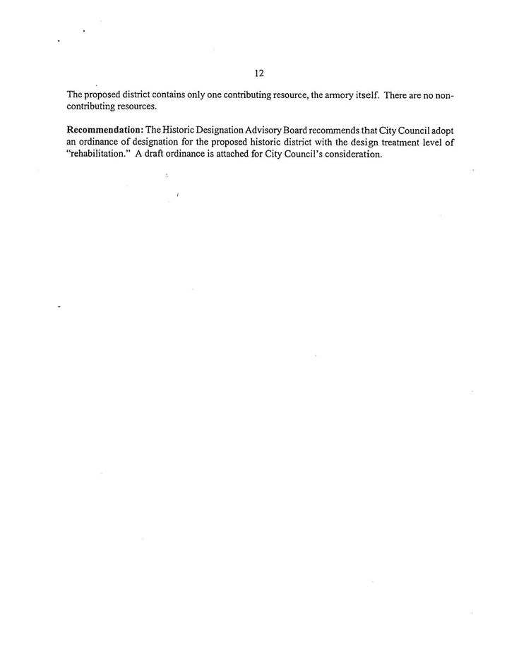 Blurry white document with two short lines of black text near the top left.