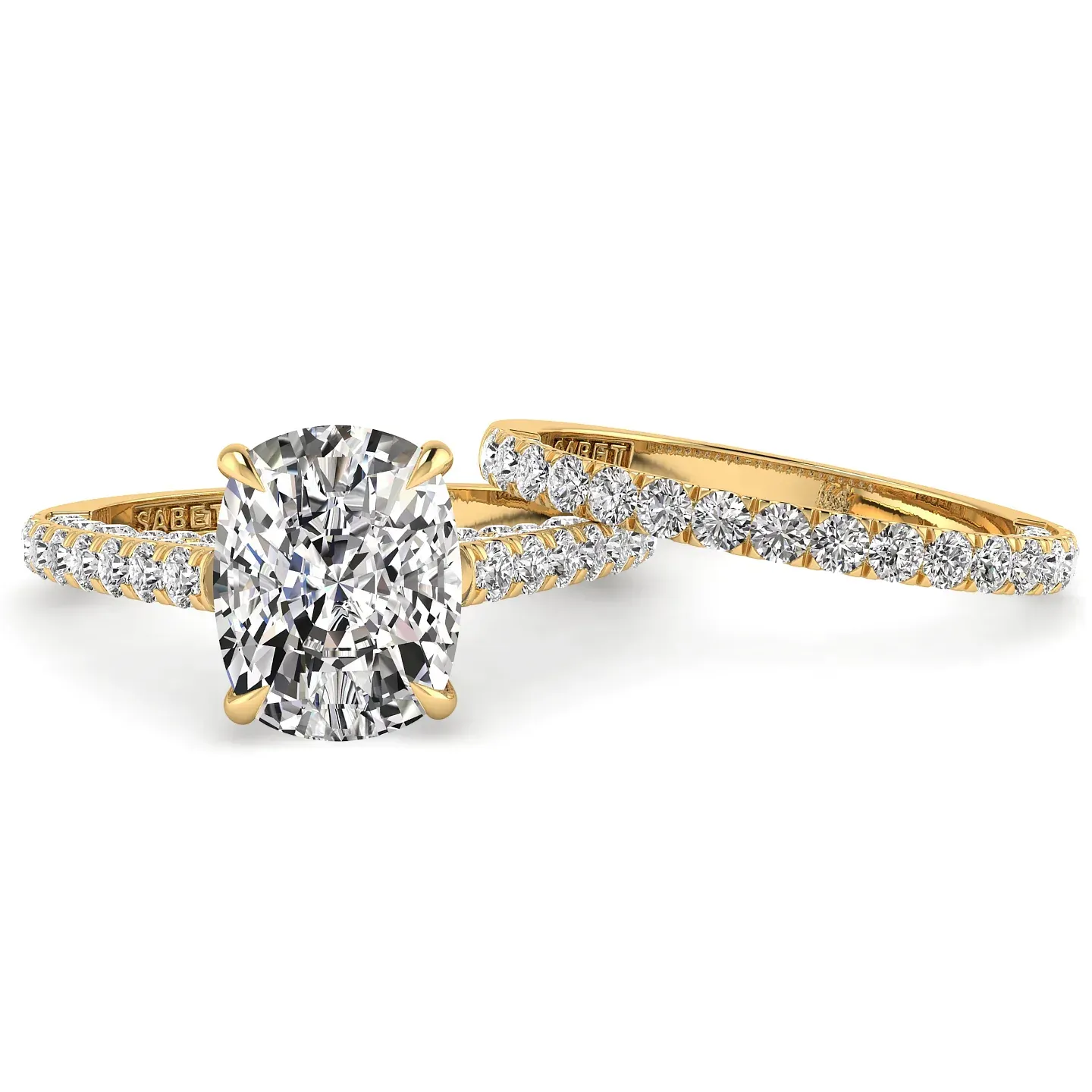 Cushion-cut diamond engagement ring with a pave band, next to a matching pave band ring, both in yellow gold.