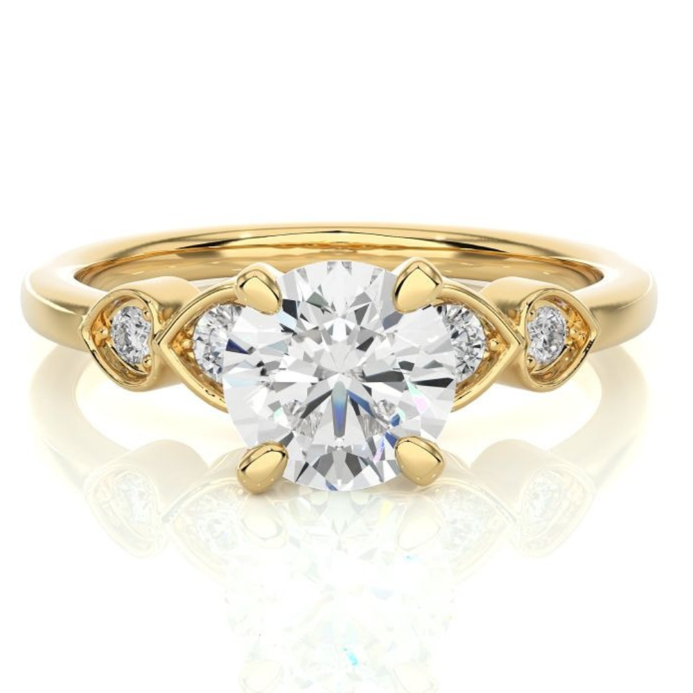 Gold engagement ring with a large center diamond and smaller side stones.