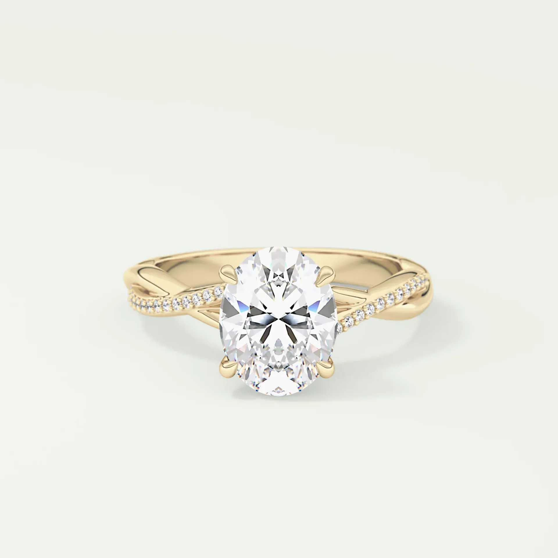 Oval diamond engagement ring with a twisted, diamond-studded band in gold.