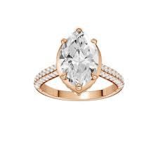 Rose gold engagement ring with a marquise-cut diamond and pavé band.