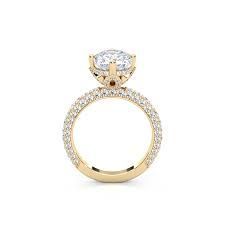 Gold engagement ring with a large center stone and a pavé band.