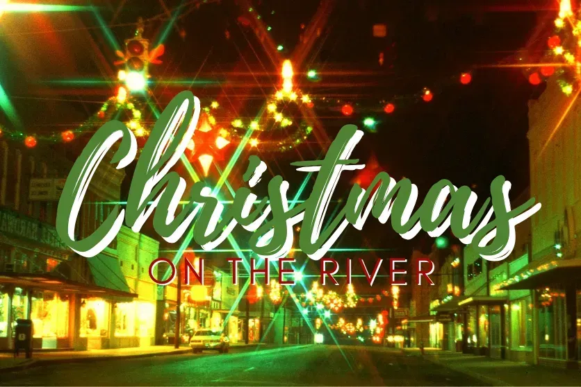 A christmas on the river poster with a christmas tree in the background