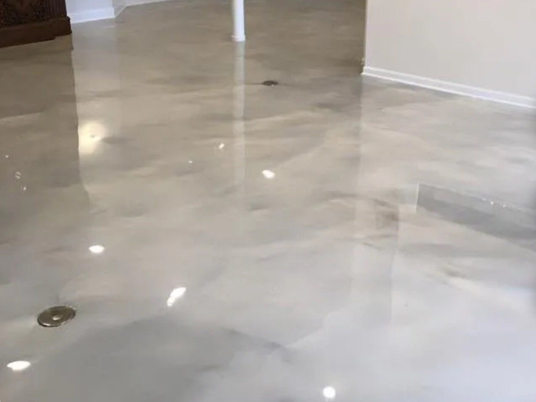 A close up of a shiny metallic floor in a room.