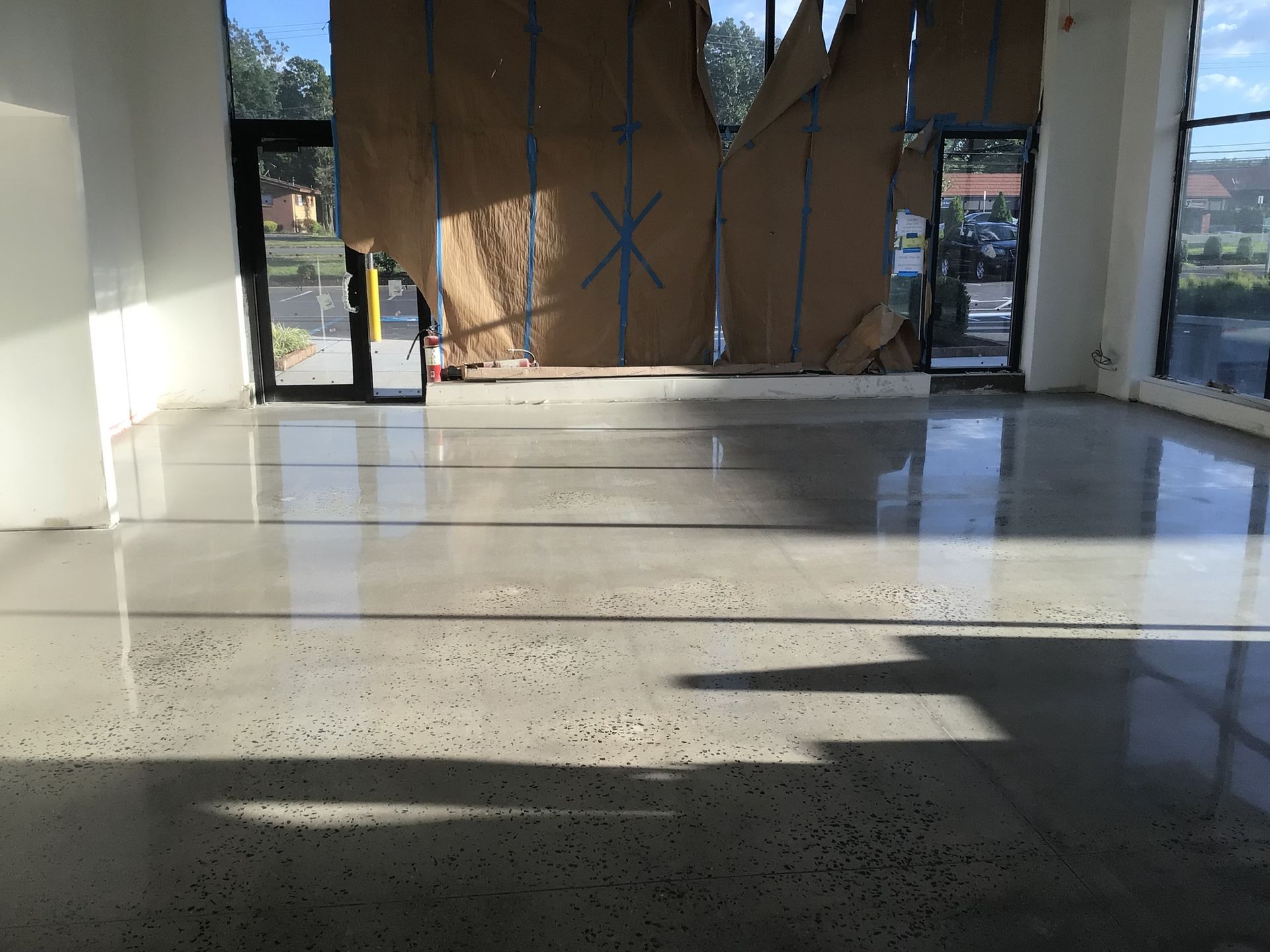 A large empty room with a shiny concrete floor