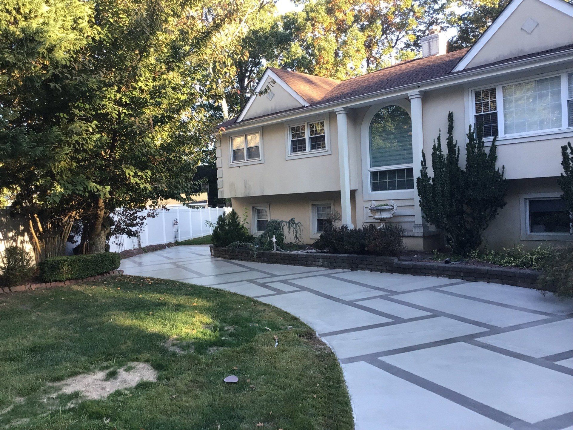 A large house with a concrete driveway leading to it