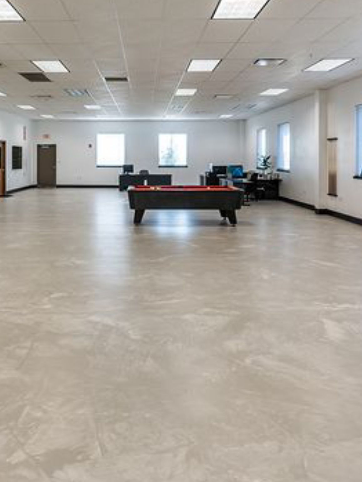 There is a pool table in the middle of the room.