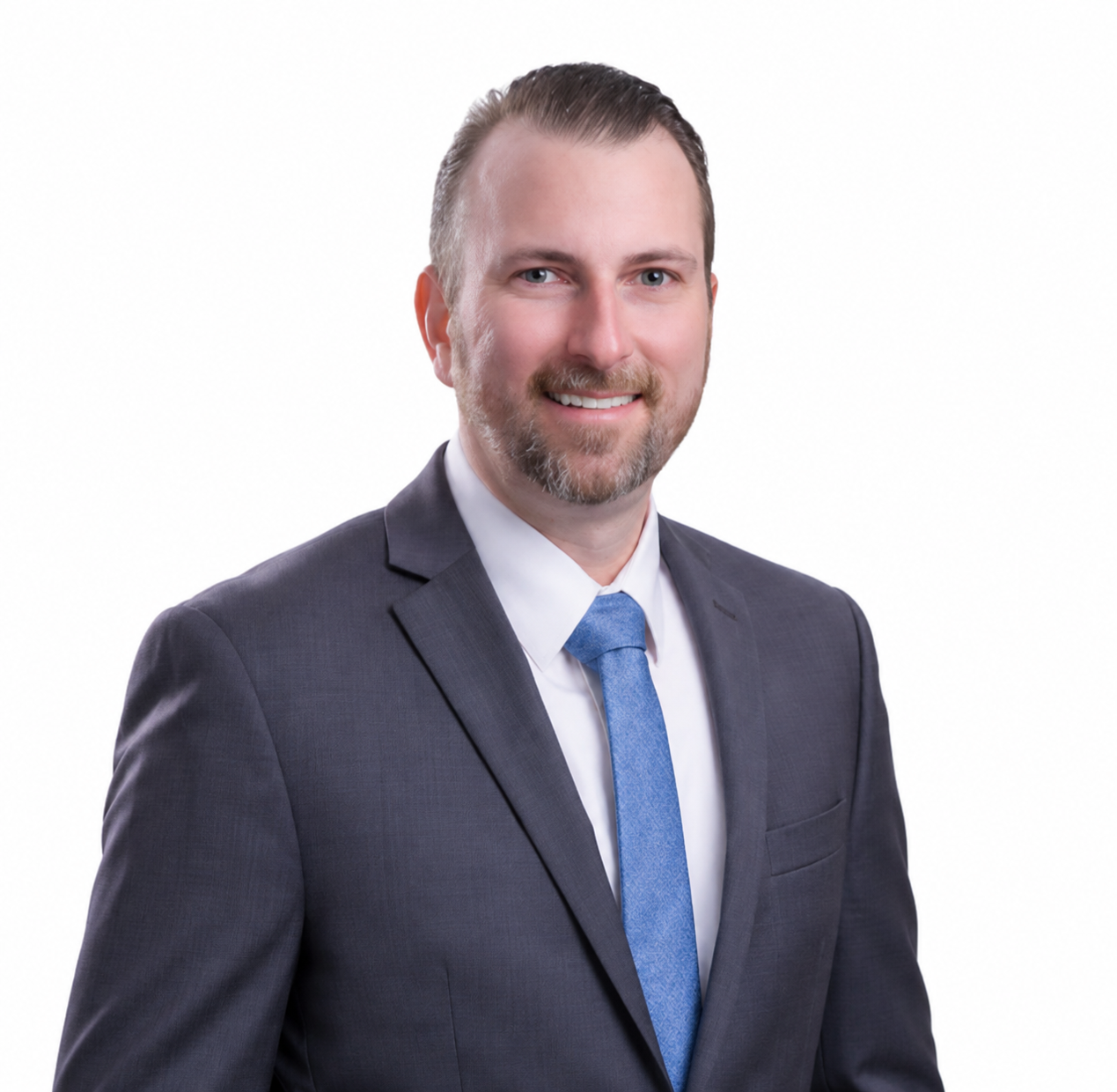 Smiling man in a gray suit with a blue tie on a white background