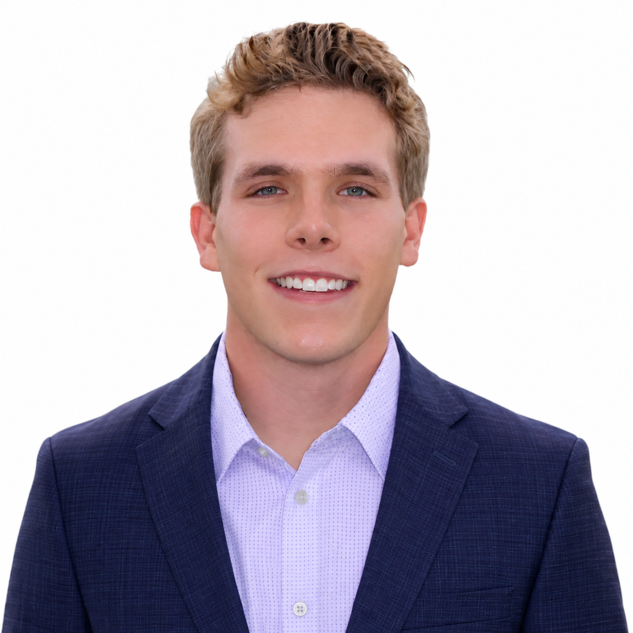 Smiling person in a blue blazer and light purple shirt on a white background