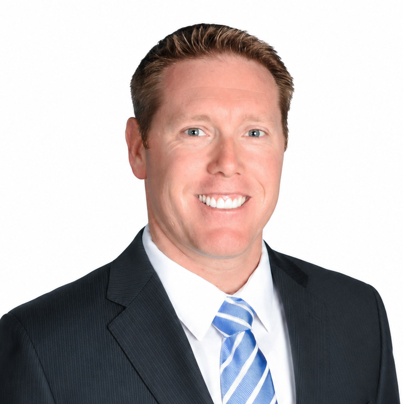 Professional headshot of a smiling person in a dark suit, white shirt, and blue striped tie on a white background