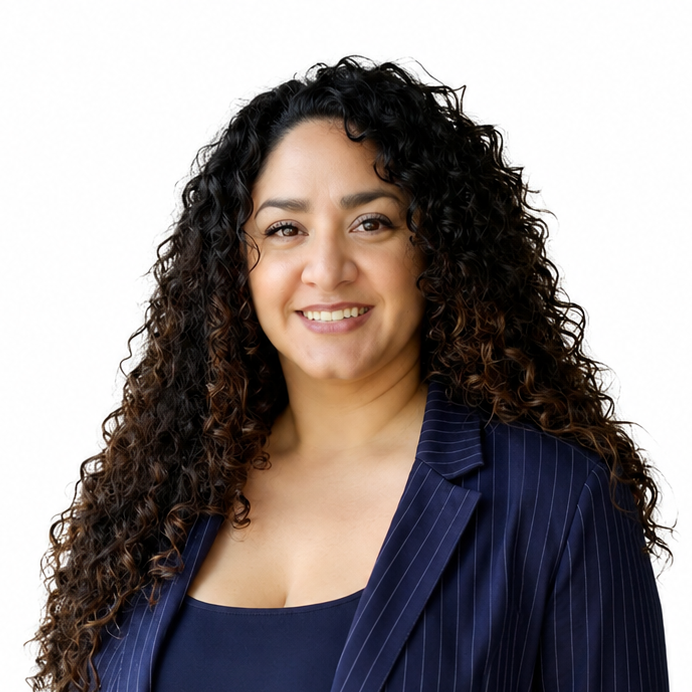 Smiling woman with curly dark hair in a navy blazer against a white background