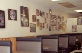 Restaurant interior with booths and wall art.