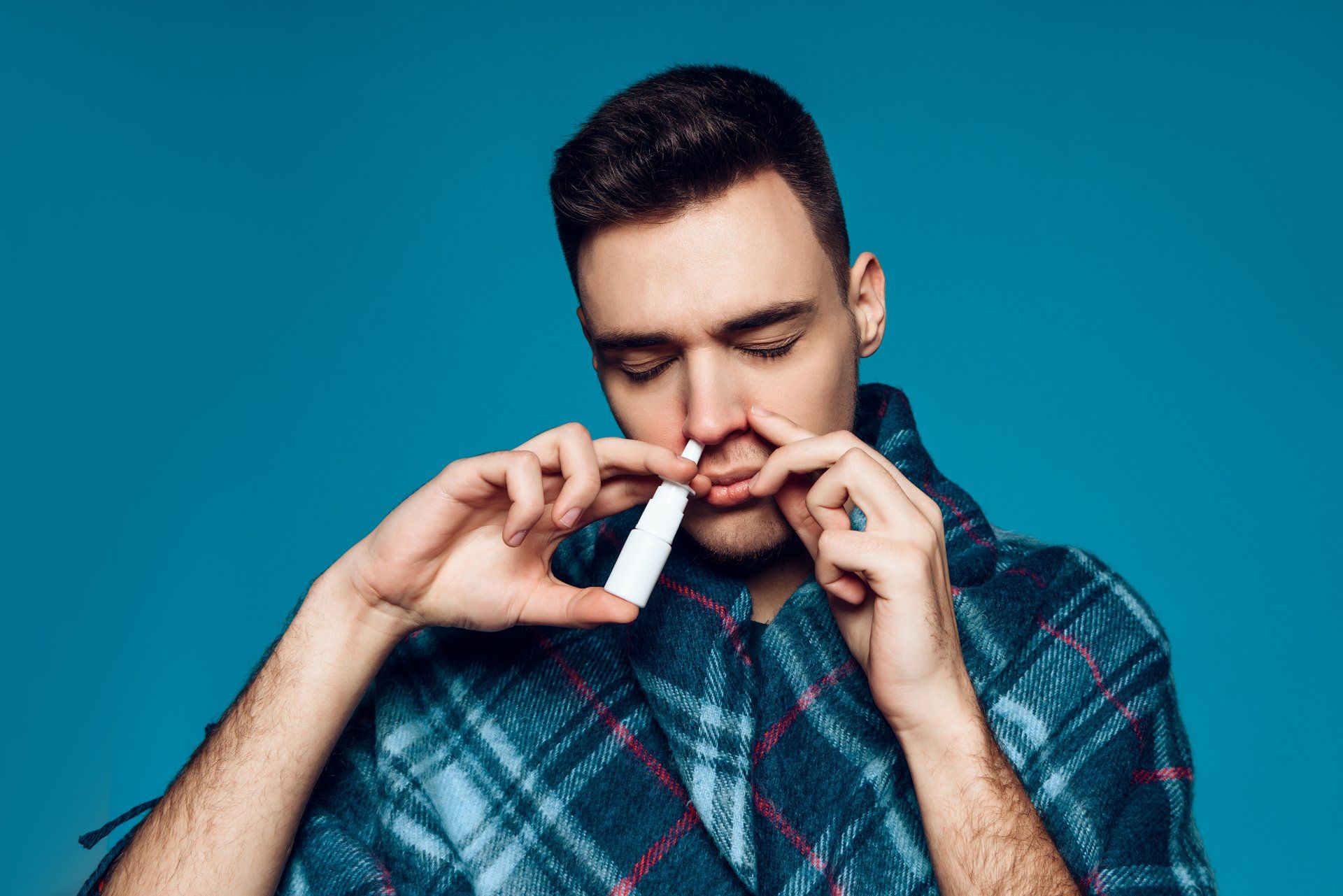 man using nasal spray