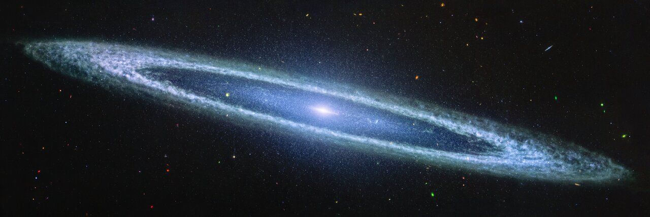 A luminous galaxy with a central bright core and surrounding rings against a dark, starry background.