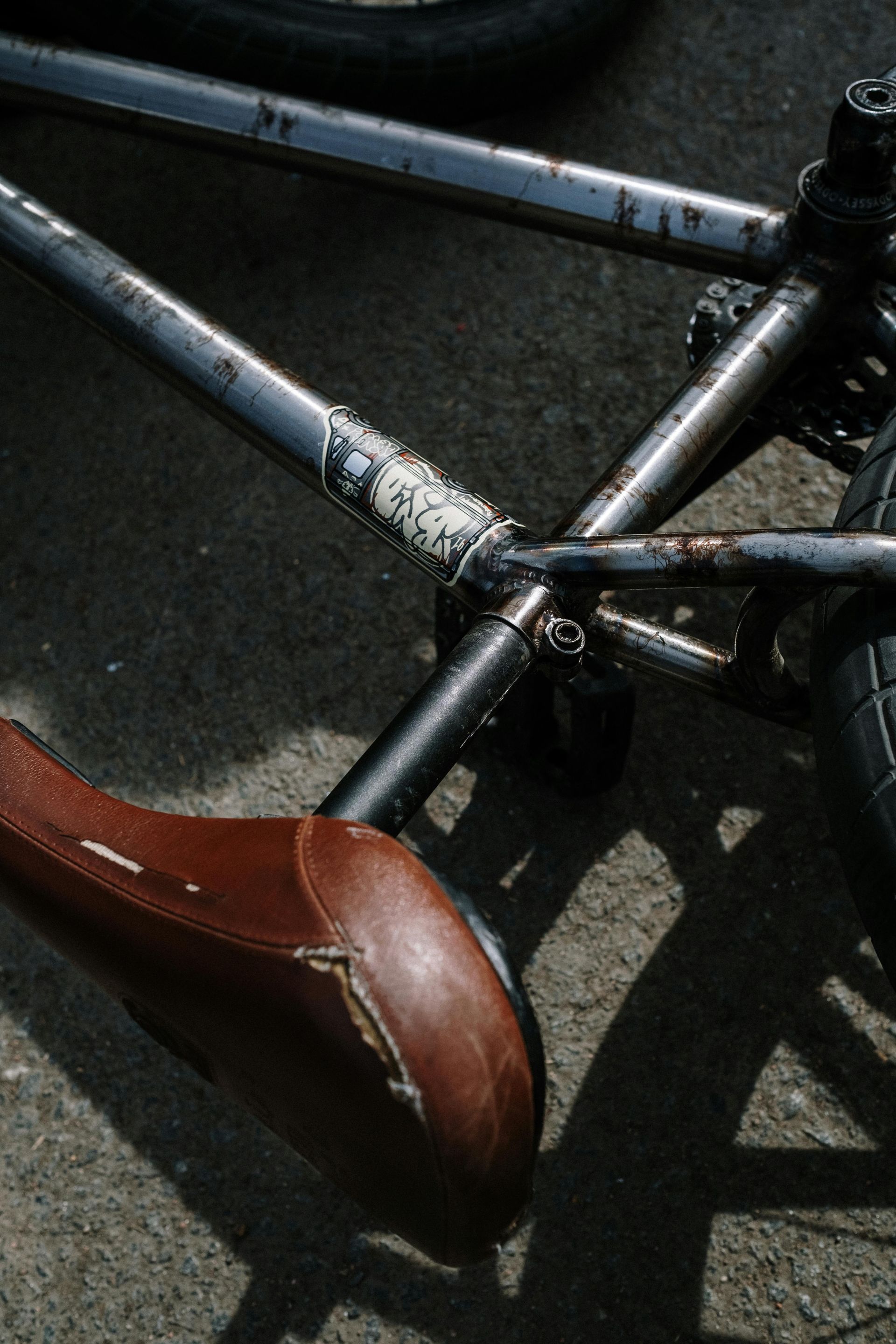 A close up of a bicycle with a brown saddle