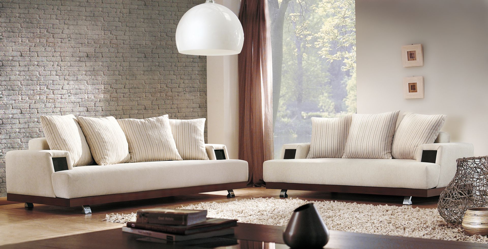 Divano beige in un soggiorno moderno; presenta cuscini decorativi, base in legno e un'ampia finestra.