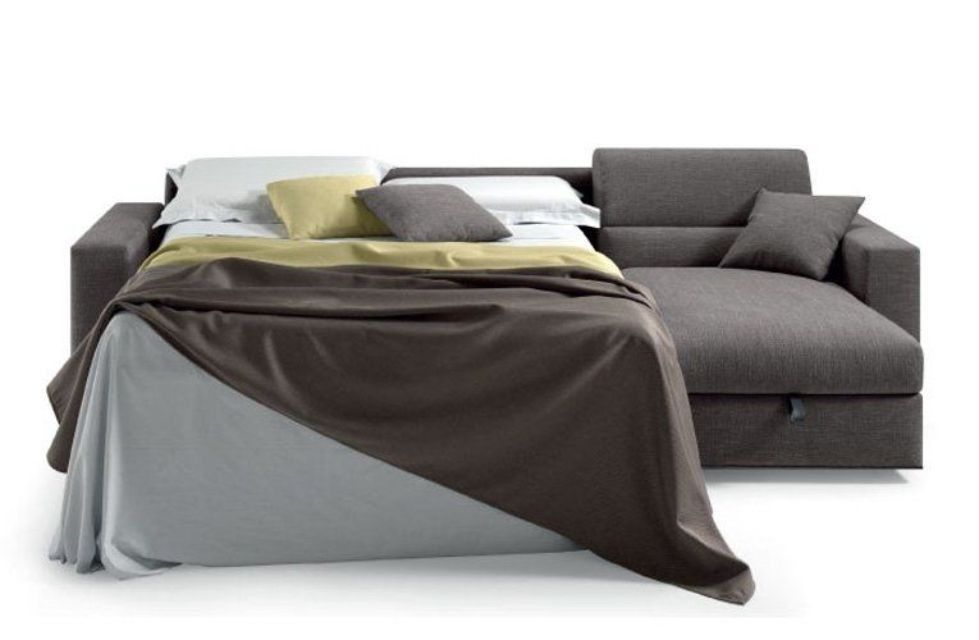 Divano componibile grigio, letto parzialmente aperto con biancheria.