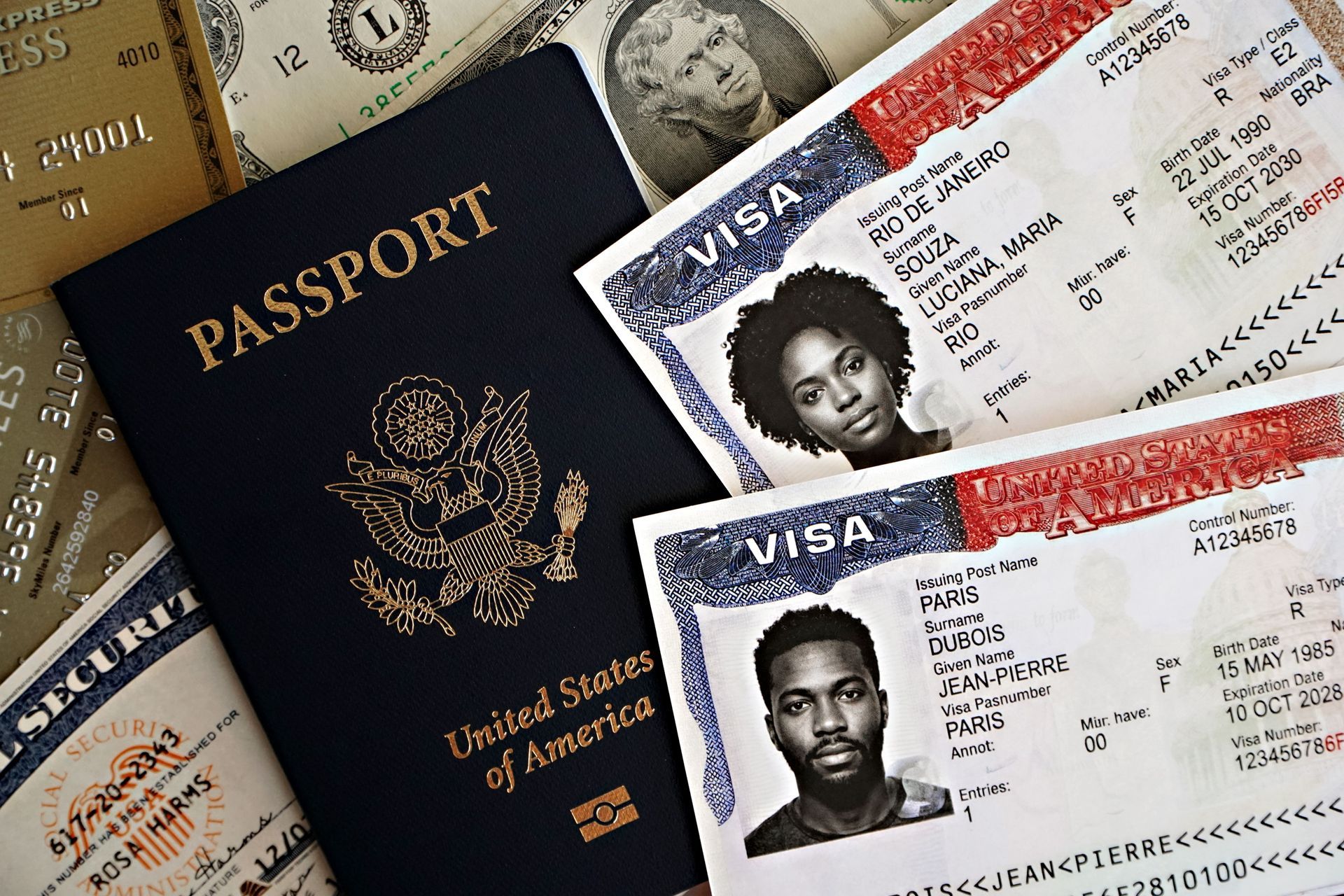 US passport beside two visa documents on a table with currency notes