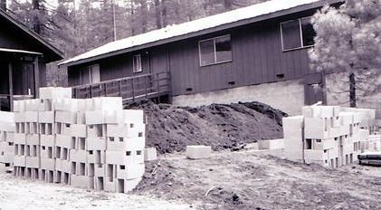 A black and white photo of a house under construction.