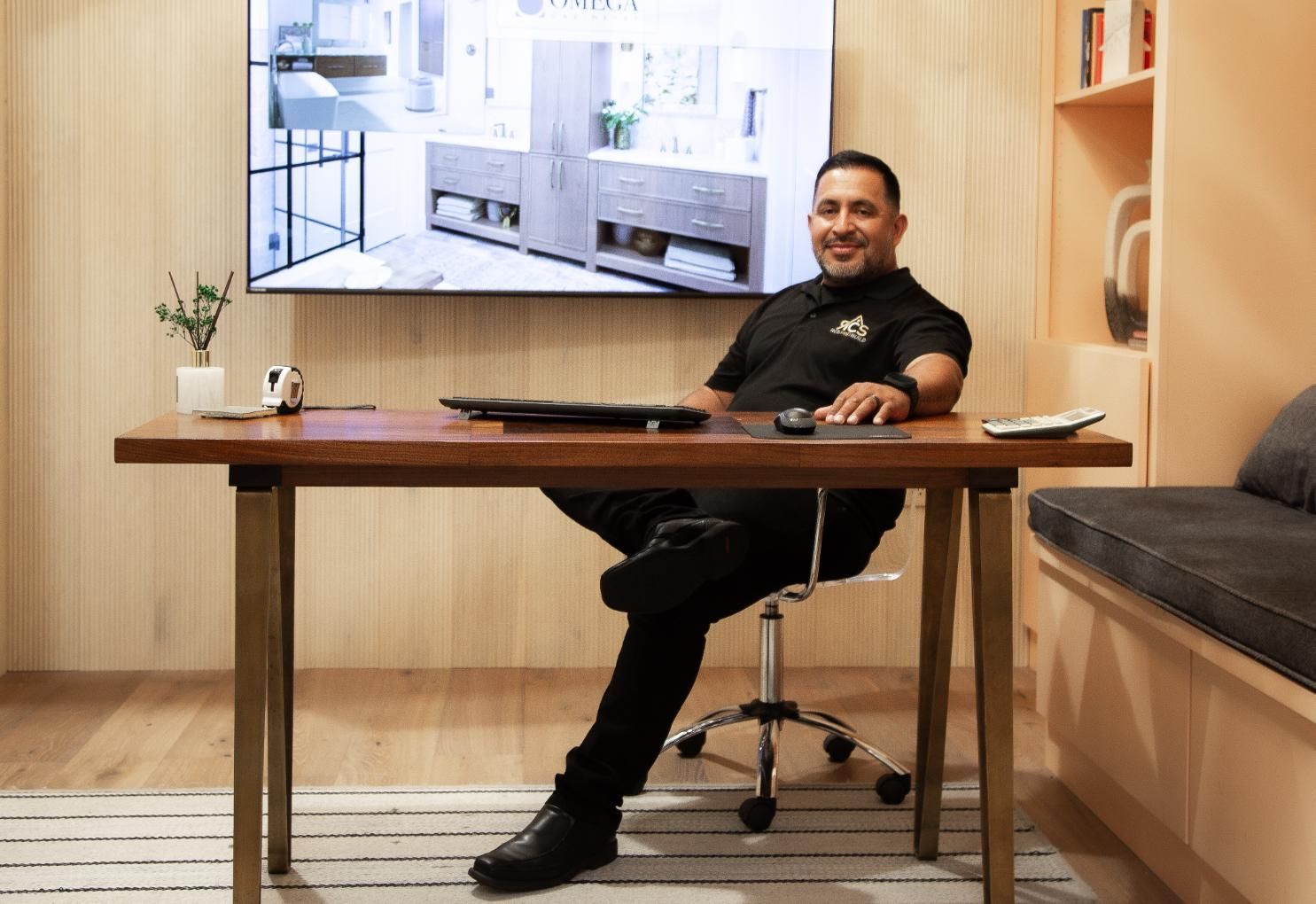 Ish sitting at a desk in a modern office