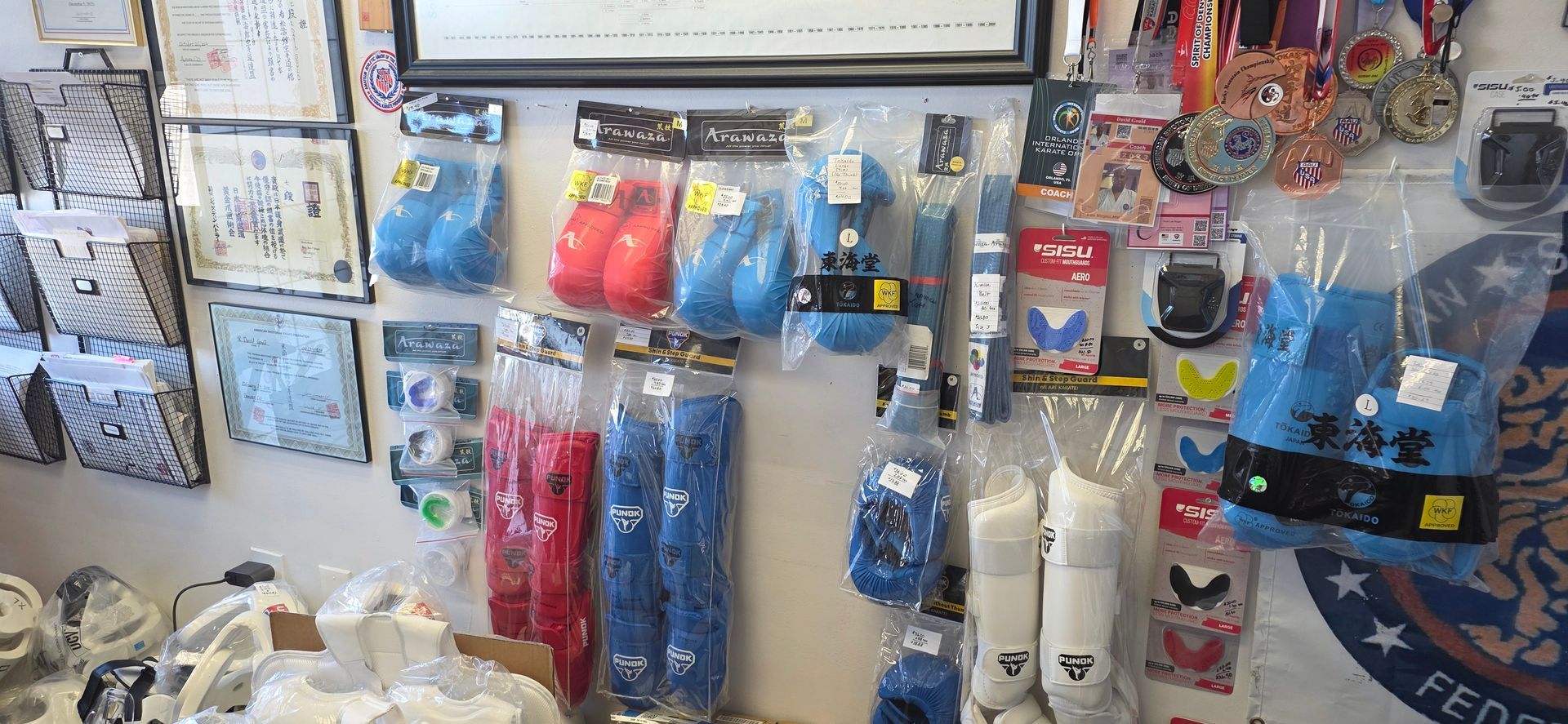Pet store display of colorful dog toys, leashes, and pet accessories hanging on a wall